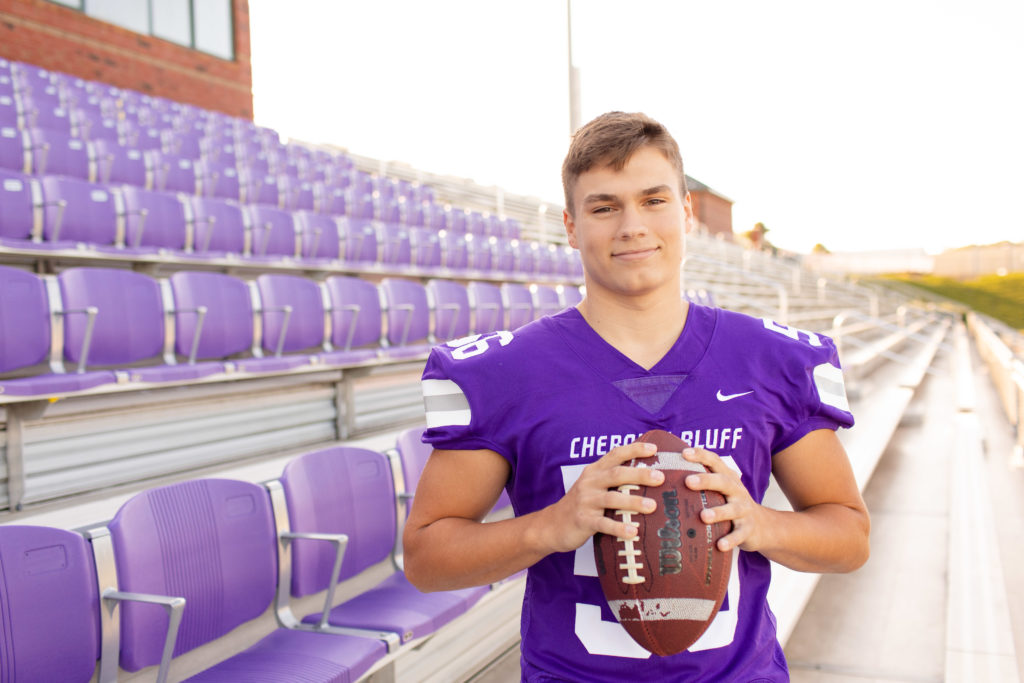 senior male football player with football