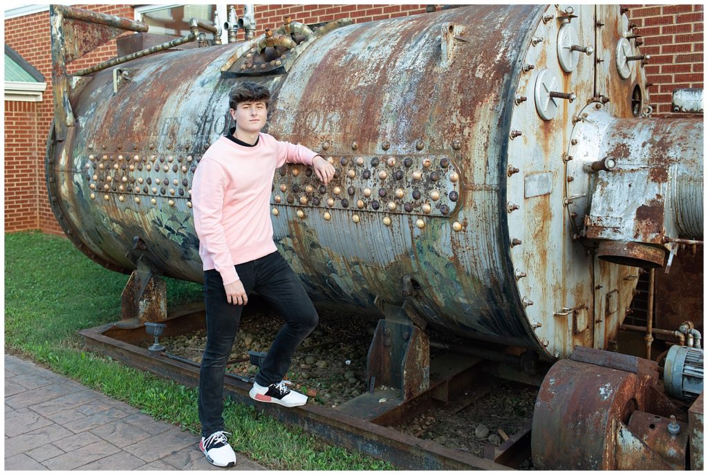 senior male posing with boiler / industrial vibe
